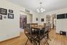 Dining area featuring wood-finish flooring and a central chandelier