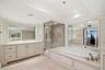 Upstairs en suite bath with large jetted tub, vanity and separate shower.