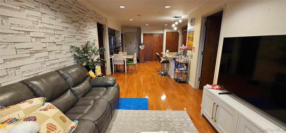 Living area featuring light wood-type flooring and recessed lighting