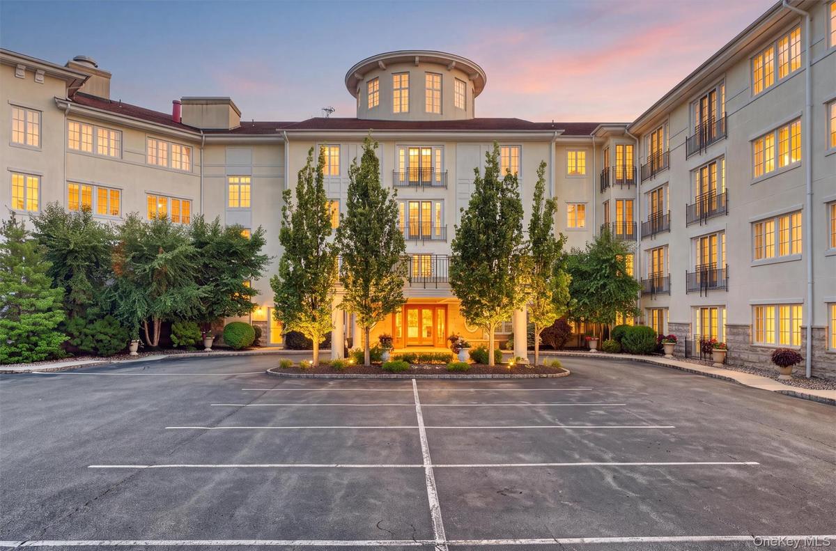 Distinguished entrance surrounded by beautifully landscaped grounds.(virtually staged dusk)