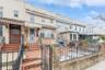 Townhome / multi-family property with a fenced front yard