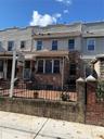 Traditional home featuring a fenced front yard and stone siding
