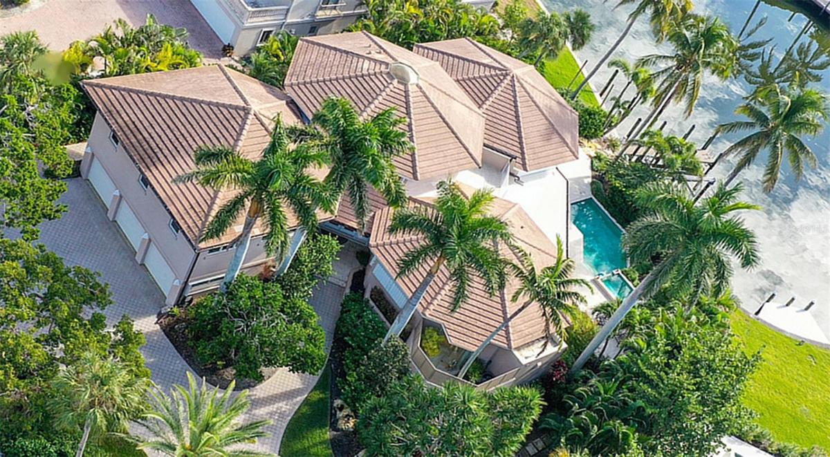 Aerial view revealing the residence’s signature three-pod architecture and the private secondary primary suite above the garage