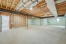 Full basement with high ceilings and outside entrance, offering excellent potential for future finished space or storage.