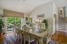 Dining area with vaulted ceiling and wood-finish flooring