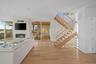Living room featuring a fireplace, light hardwood / wood-style flooring, and a wall of windows