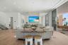 The open floor plan is surrounded by 11 and 10 foot Floor-to-ceiling Premium ES Insulated Sliders with sweeping Gulf views
