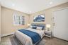 Bedroom featuring a baseboard heating unit, recessed lighting, light tile patterned floors, and cooling unit