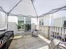 Expansive wooden deck with a white tent