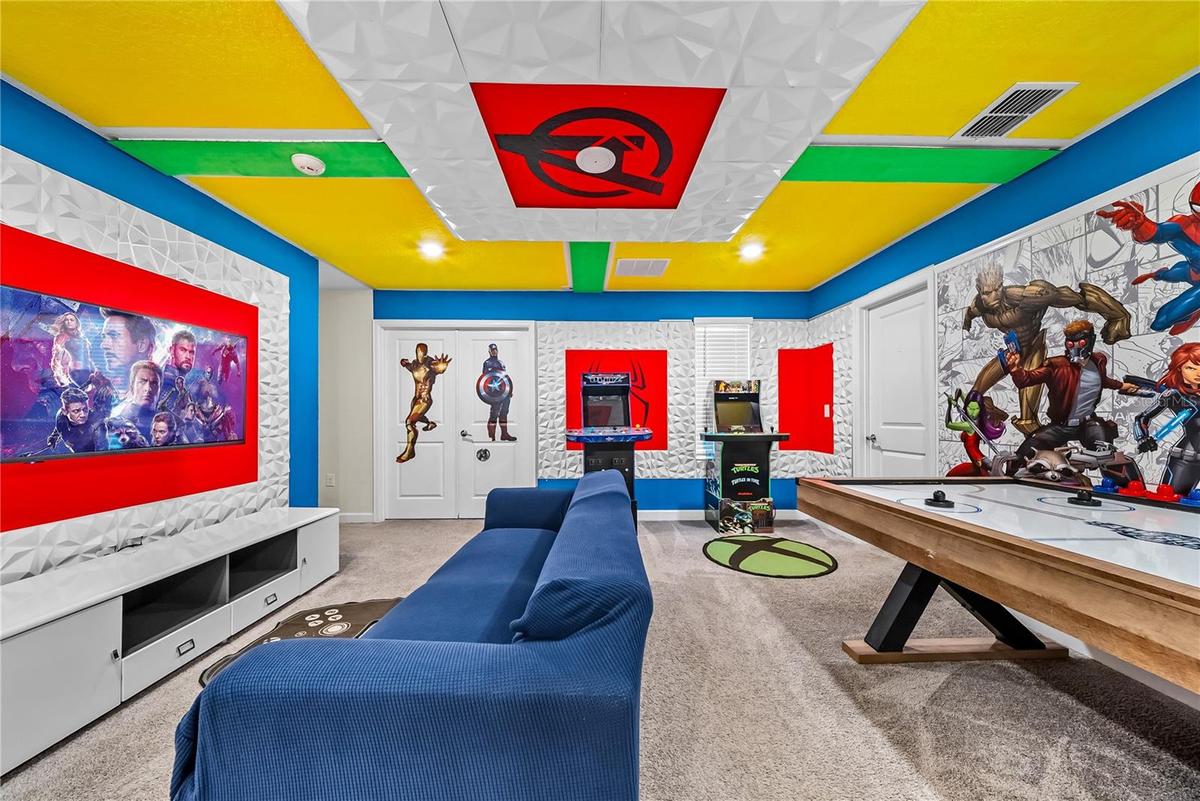 Avengers themed arcade game room with arcade games, pool table, smart TV