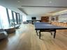 Playroom featuring a tray ceiling, a glass covered fireplace, recessed lighting, and light wood finished floors