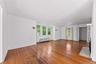 Living room with hardwood floors, great light and a fireplace.