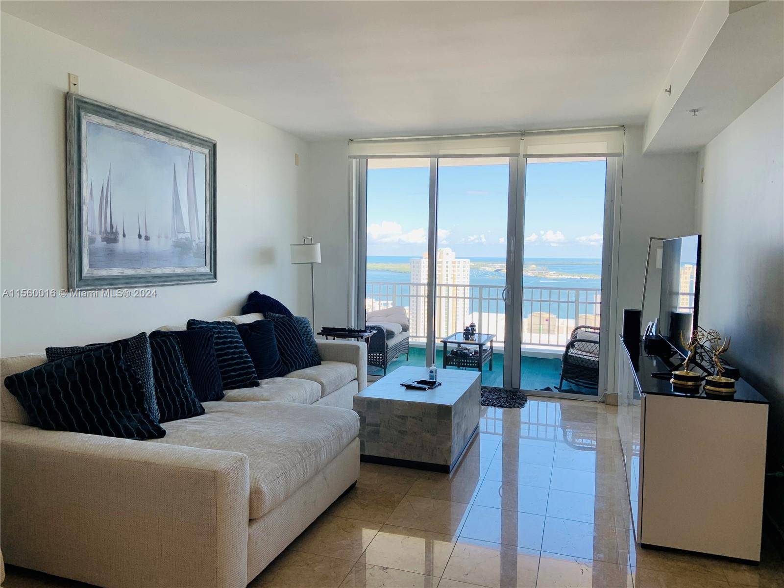 Unobstructed views of bay and skyline from this high floor residence in prestigious Brickell Key Island.