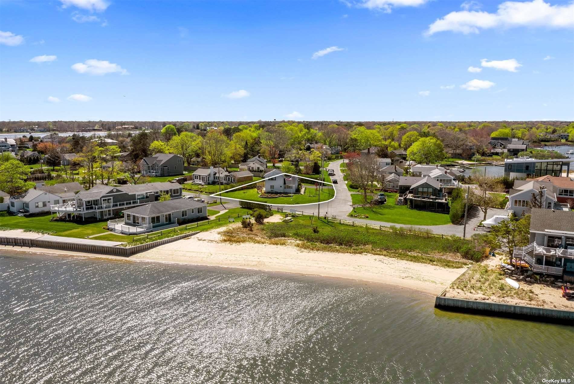 A truly unique, one of a kind opportunity to own a turn key home positioned at the southernmost tip of 'Hampton Point', East Quogue's premier private bayfront community.