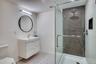 Bathroom featuring vanity, toilet, and walk in shower