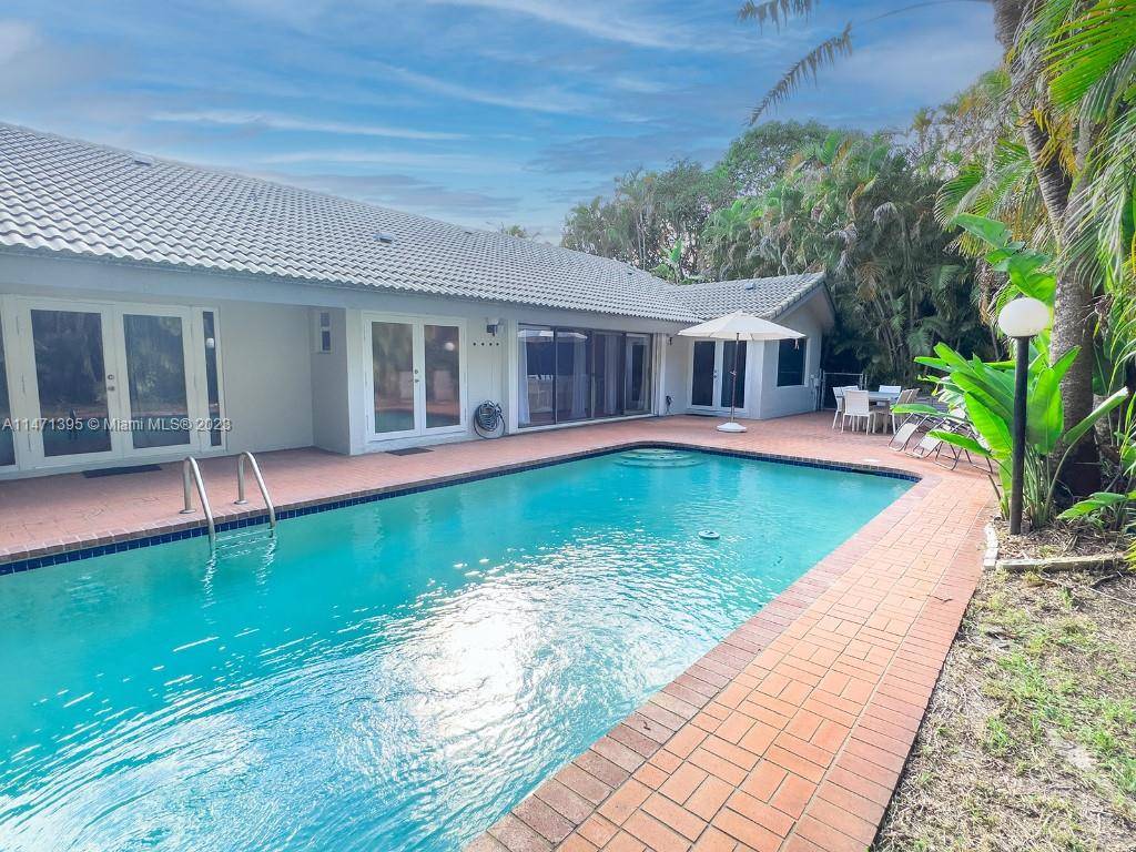 Your luscious backyard oasis with private saltwater pool in Coral Springs awaits !