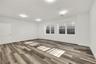 Spare room featuring baseboards and light wood finished floors