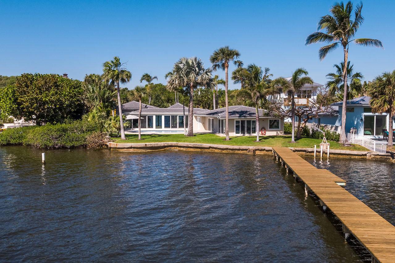 This exceptional property presents stunning intracoastal views upon entering the modern, meticulously renovated home.