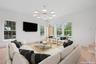 Living room featuring a chandelier, wood finished floors, and baseboards