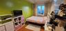 Bedroom with wood finished floors and baseboards