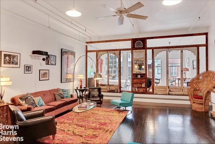 This open artist's loft is furnished with exquisite taste and a collection of vintage one of a kind pieces.