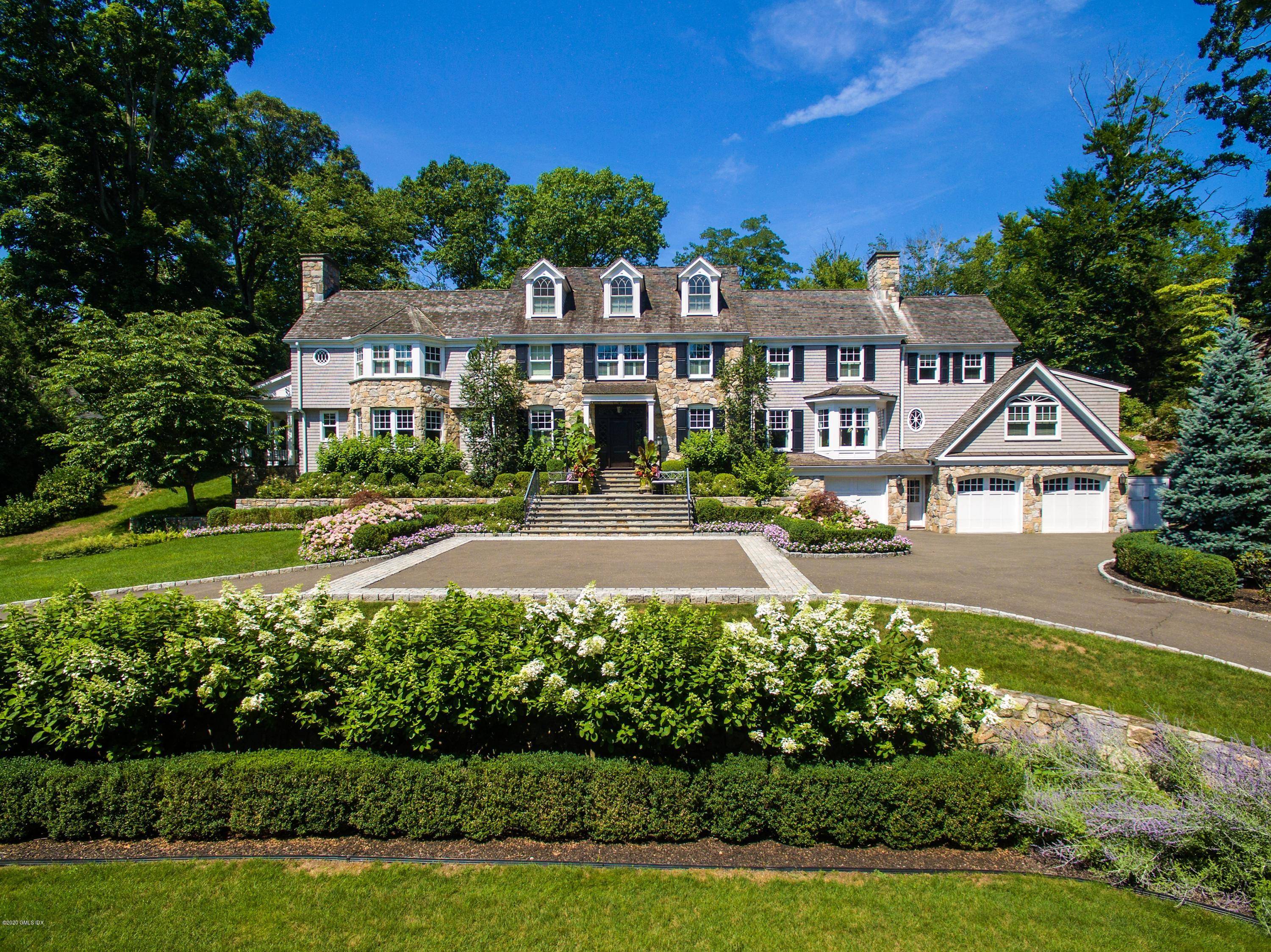 Stunning six bedroom Colonial epitomizes modern sophistication set atop a manicured.