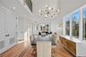 Dining space with recessed lighting, a chandelier, light wood finished floors, radiator heating unit, and a high ceiling