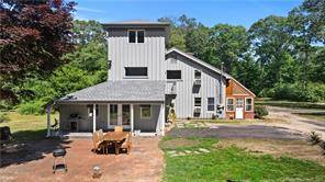 This secluded contemporary farmhouse has 3 bedrooms, 2 full baths and is set on just over 7 private acres but less than five minutes from schools and Stonington Village.