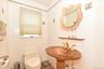 Bathroom with toilet, sink, and tile walls
