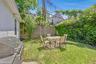 Private backyard space featuring a stucco exterior wall and a concrete retaining wall