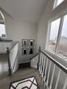 Stairs to second level with additional family room