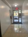 Doorway to outside with marble finish floors and baseboards