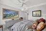 Guest bedroom (2nd primary bedroom) w/ fan w/ remote & crown molding, marble flooring.