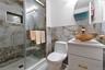 Bathroom featuring a glass-enclosed shower with an integrated niche and bench