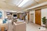 Living room with stairway and a drop ceiling