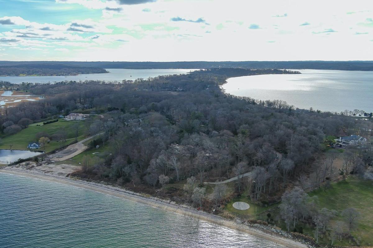 View of property location with a large body of water and a forest
