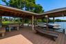 Boat Dock104 Feet Long Wooden Boat Dock23 Ft +/- Boat Lift with a remote dropDual Jet Ski LiftsGazebo with Wooden Table and BenchBuilt In StorageEquip