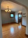Large dining room with hardwood floors and chandler