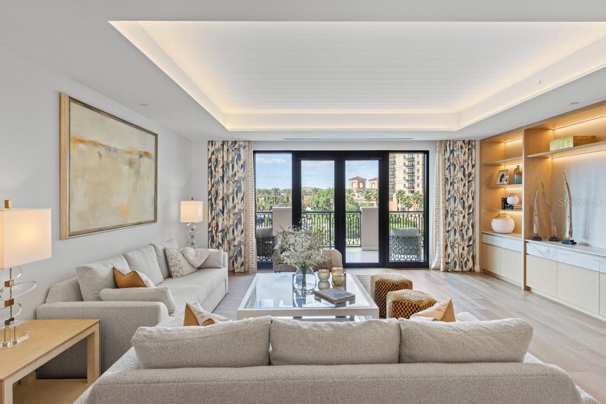 Spacious open concept living room with tongue and groove ceiling details and lighting