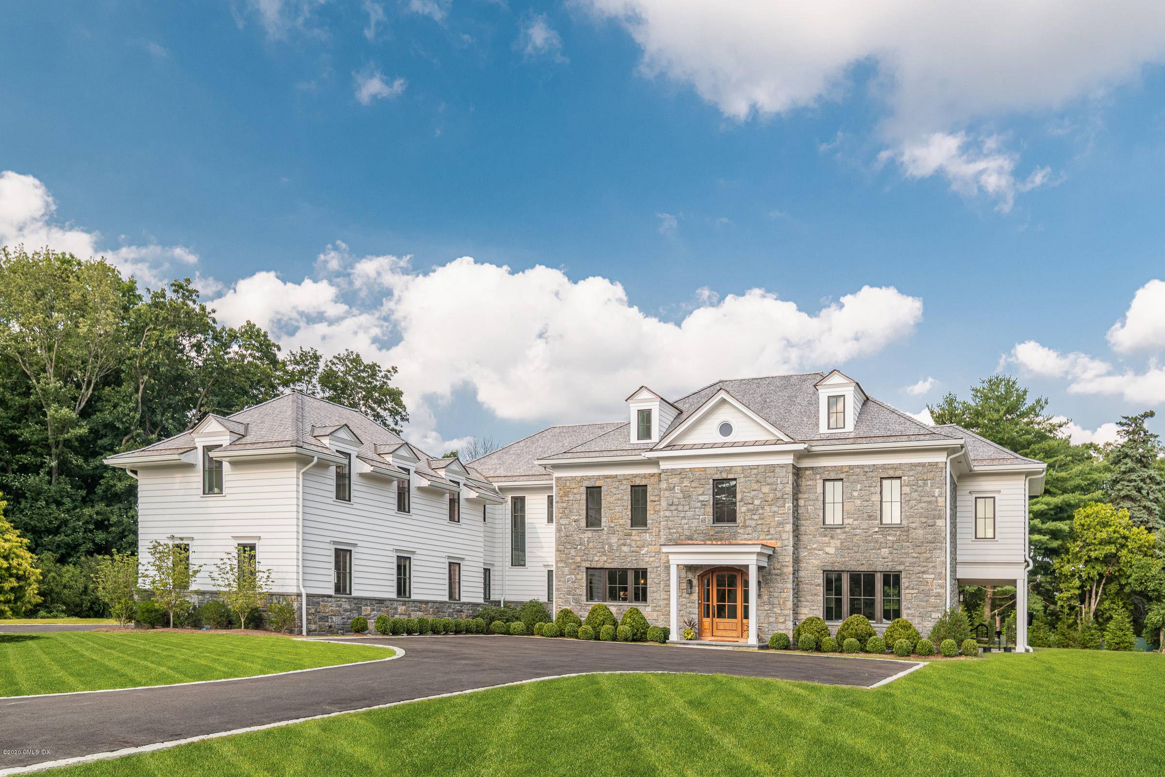 Nestled on a two acre private lot, the drive up to this stunning almost 9000 square foot Connecticut estate is picturesque, a homeowner's dream.