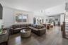 Living room with hardwood / wood-style floors, a towering ceiling, and french doors