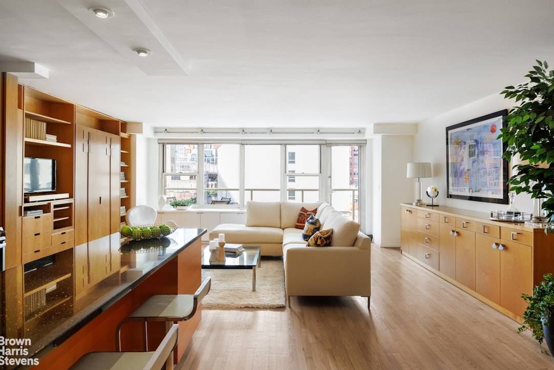 This turn key apartment has been classically renovated for a natural, modern appeal with elegant built in cabinetry and bookshelves throughout.