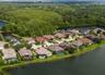 Aerial view showcasing the pond-front setting and natural backdrop.