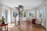 Sitting room with crown molding, light wood-style flooring, and stairs