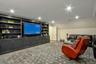 Den with built in shelves and crown molding