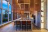 Kitchen featuring decorative light fixtures, a center island, floor to ceiling windows, a breakfast bar area, and dark wood-style floors