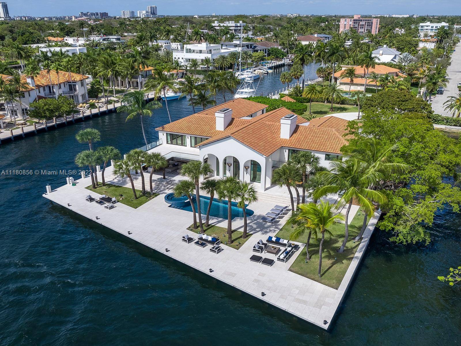 This Las Olas Isles estate has the rare distinction of occupying its own private peninsula, with spectacular views and approx.
