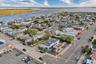 Aerial perspective of suburban area featuring a large body of water