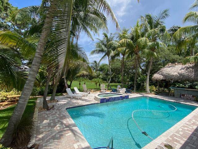 Enjoy your own tropical private resort with heated pool and spa, huge open porch and Tiki Bar.
