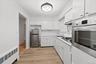 Kitchen with window over sink, new appliances, new luxury vinyl flooring and freshly painted.